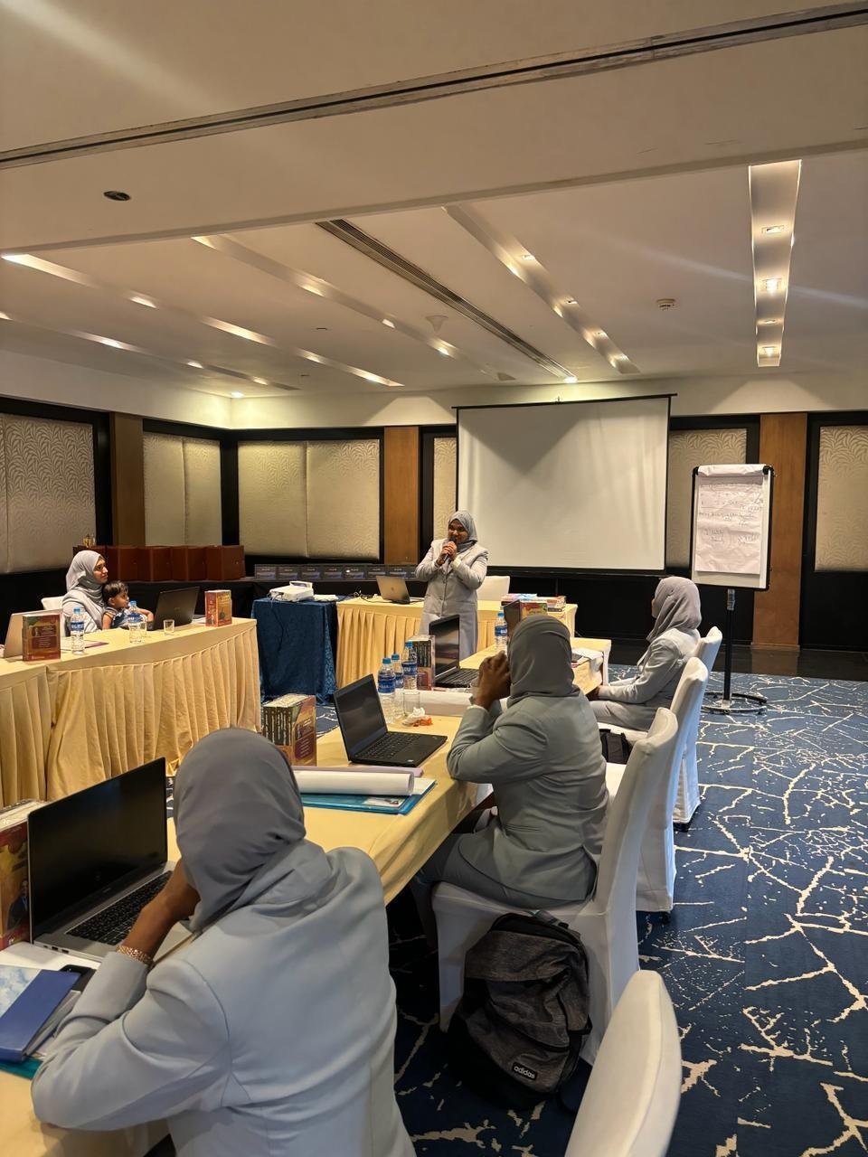 Participants seated at a parenting workshop in a conference hall